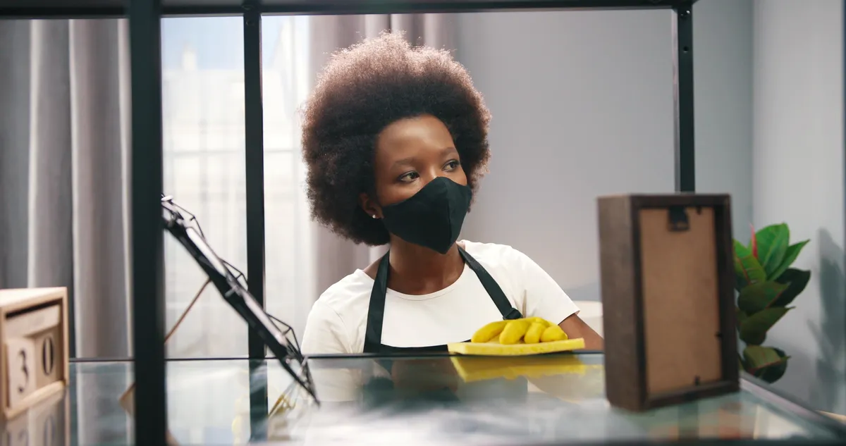Cleaner wiping a table in a home